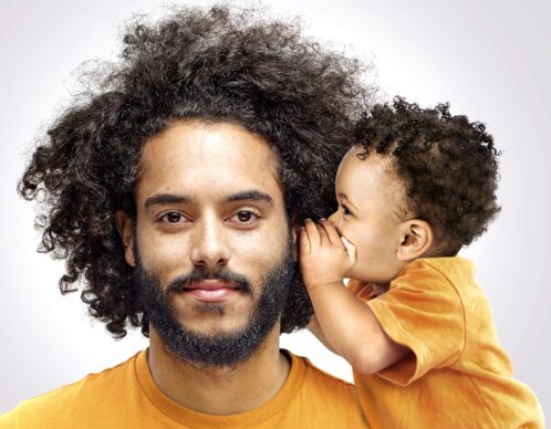 Portrait of bearded young man with curly brown hair wearing white t shirt